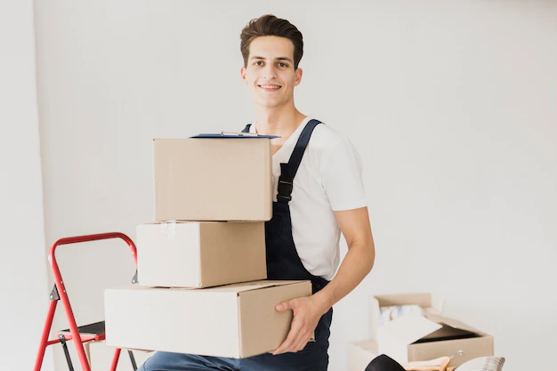 smiley-young-man-holding-carton-boxes_23-2148273282